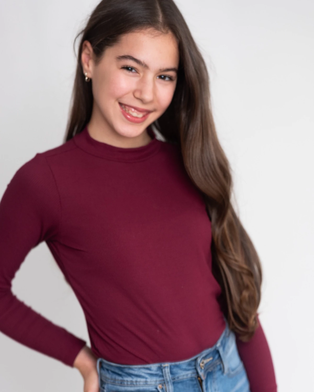 Samara standing in a burgundy top